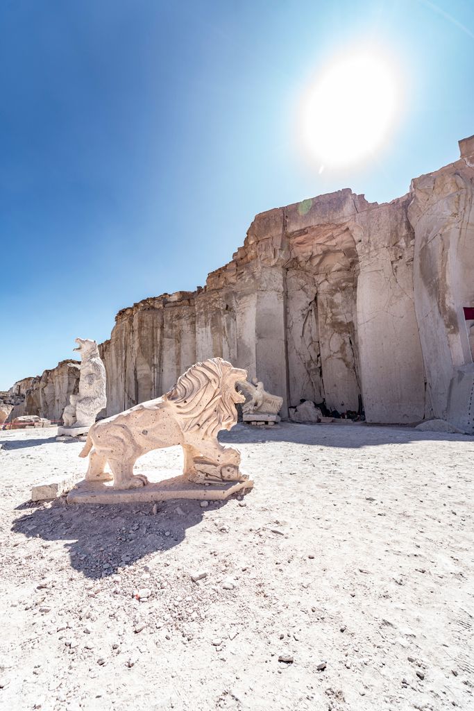 A sculpted stone lion under the bright sun in Las Canteras de Sillar, Arequipa, Peru.